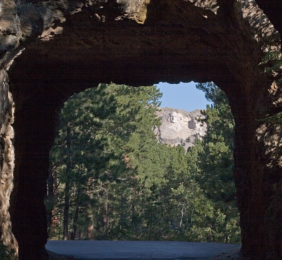 Mount Rushmore framed in the opening of a rock tunnel on Iron Mountain Road in the Black Hills of South Dakota