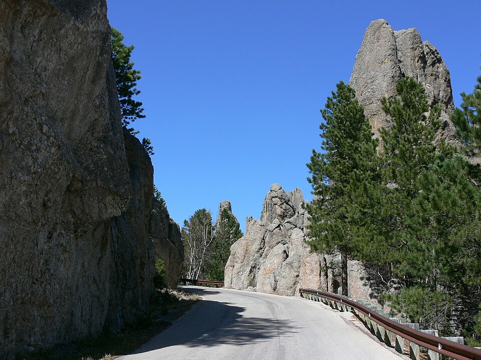 The Needles Highway winding between tall granite spires and ponderosa pines in Custer State Park, South Dakota